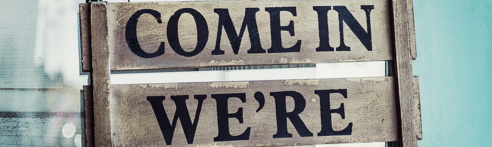 Image of a handmade, handcrafted wood sign that says, “Come In We’re Open”