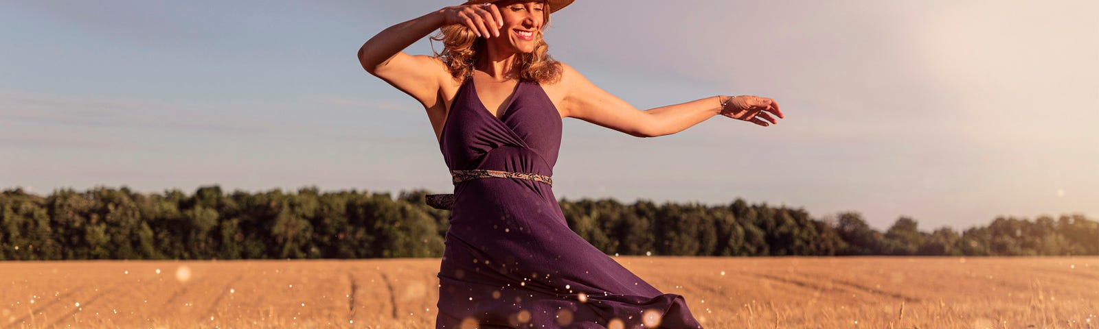 Here is a young woman, dancing in a beautiful open field under the sun, singing a song of love.