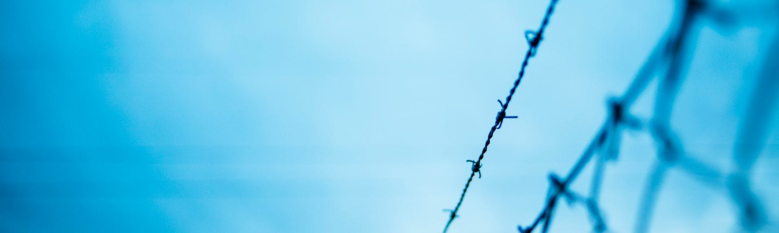 A wire fence with air pollution above.