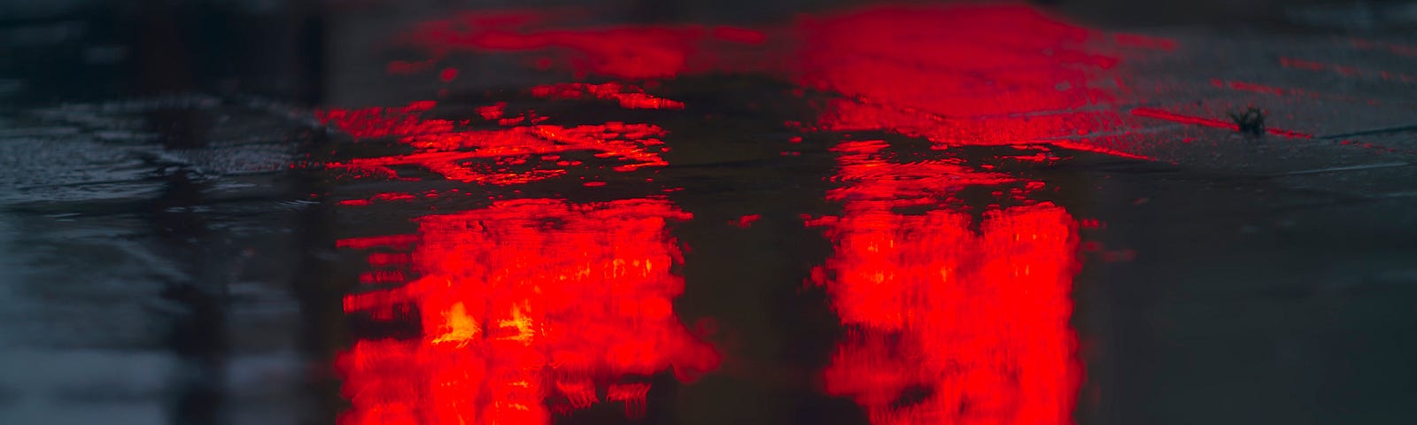 Puddle reflecting red light.