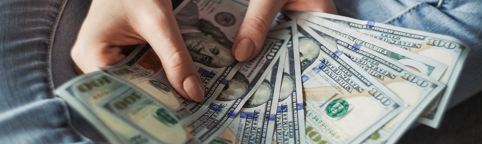 Here is someone with a handful of hundred dollar bills, about to purchase a used pen at the college bookstore.