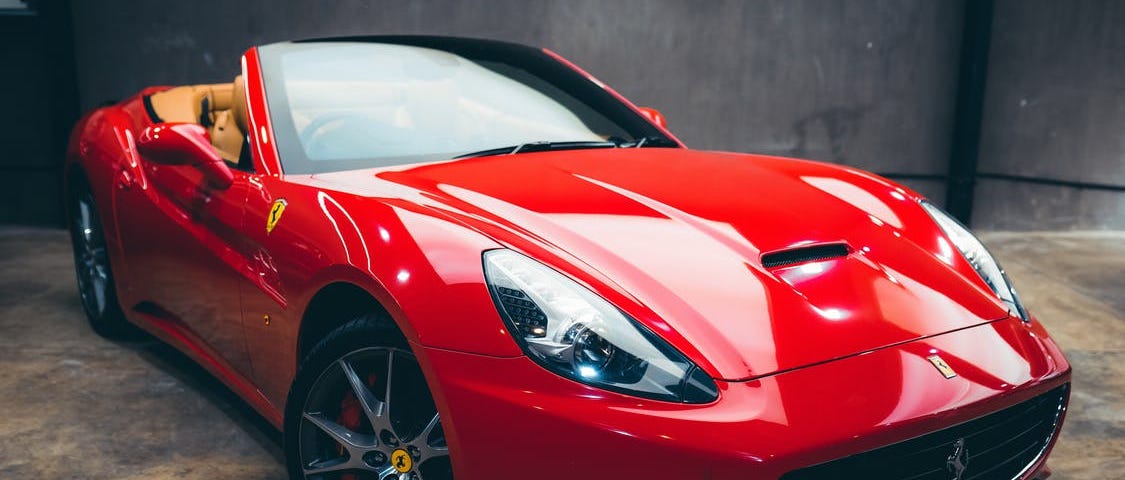 A flashy red sports car inside a garage