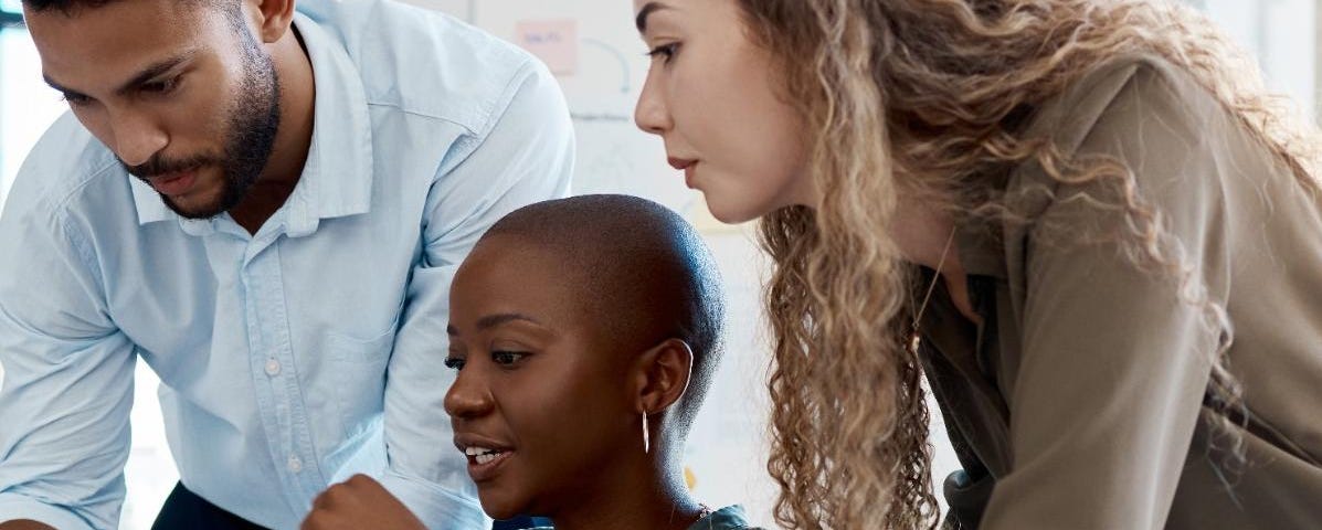 Three people looking at a computer screen. Photo by Anela Ramba/peopleimages.com/Adobe Stock