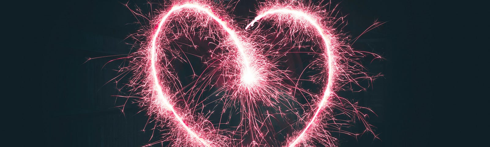 electrified pink heart in a black background