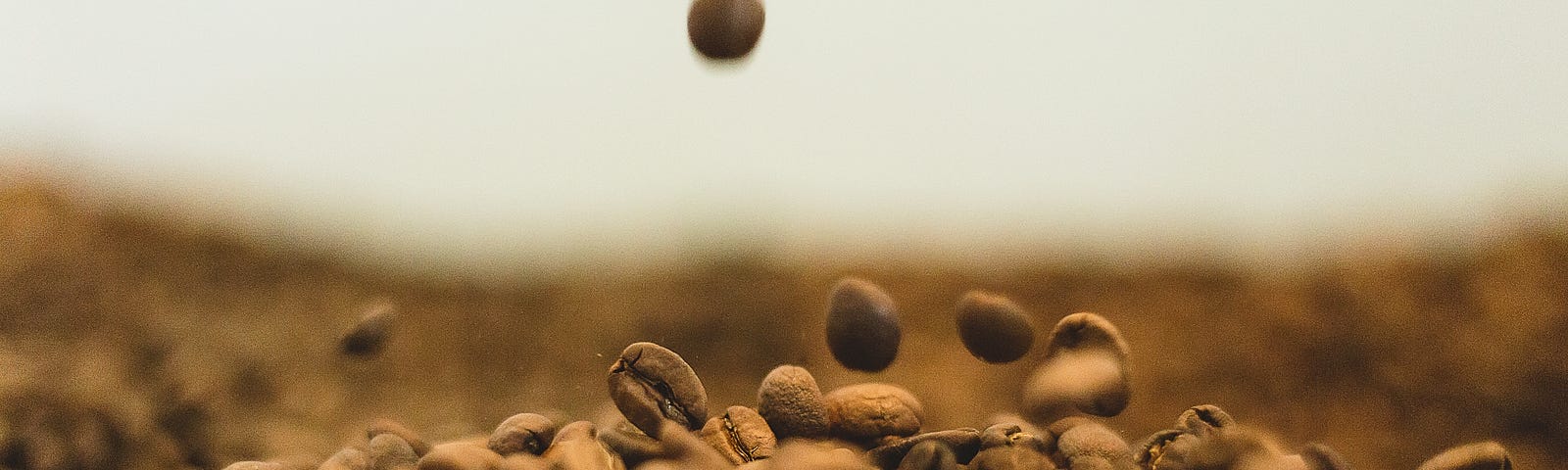 Brown coffee beans drop from above into a pile on the ground. Close-up image, partially blurred. MIXING ALCOHOL AND A HIGH-CAFFEINE ENERGY DRINK is popular among younger adults. Unfortunately, this drink type can mask alcohol’s effects, facilitating over-drinking.