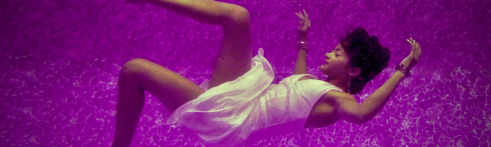 A woman falling, on a purple background.