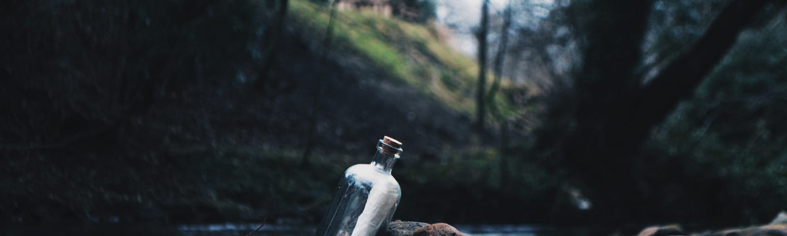 Bottle with a message inside floating in a river, symbolizing communication and connection through messages in water.