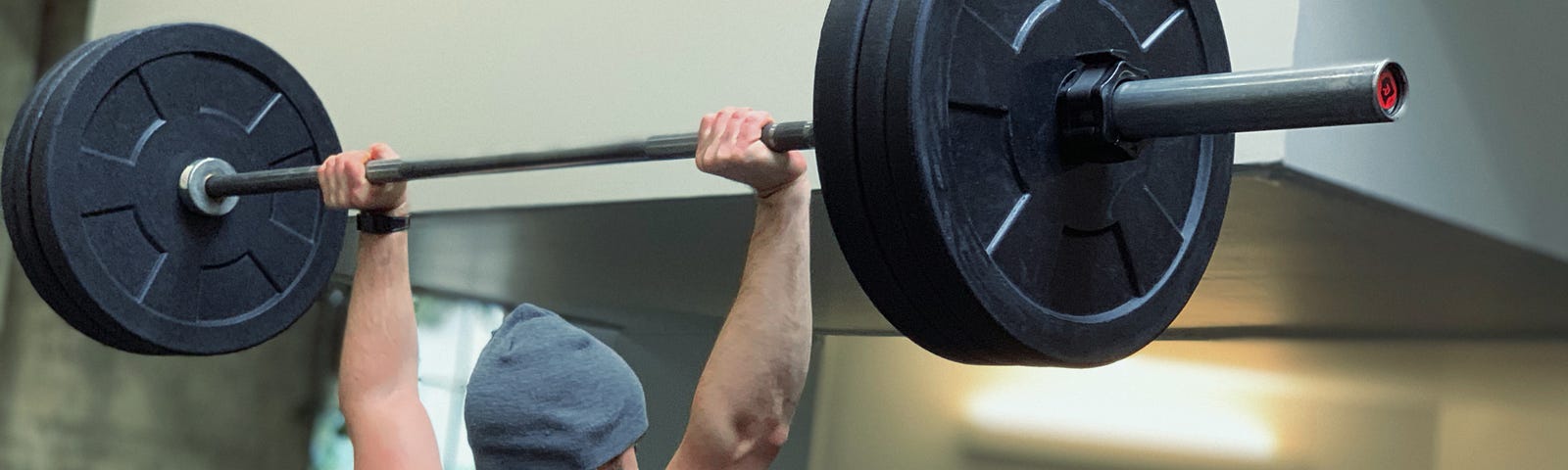 Someone performing overhead shoulder press