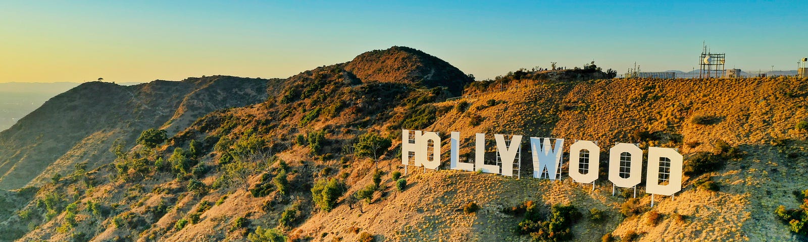 The famous HOLLYWOOD sign on the side of a hill.