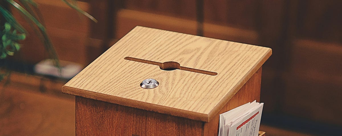 A Tithe/Offering box on a table in a church