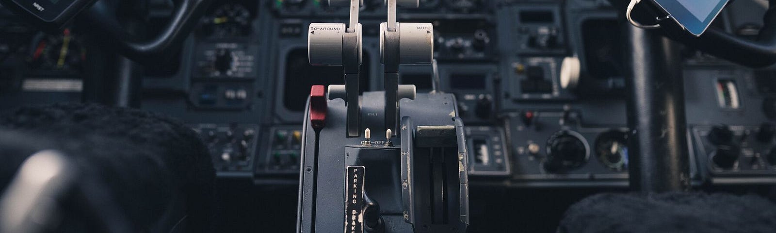 Image shows a cockpit with a thrust lever, many buttons, switches, and screens that is supposed to visualize complexity and potential of Microsoft Configuration Manager (SCCM or MECM).