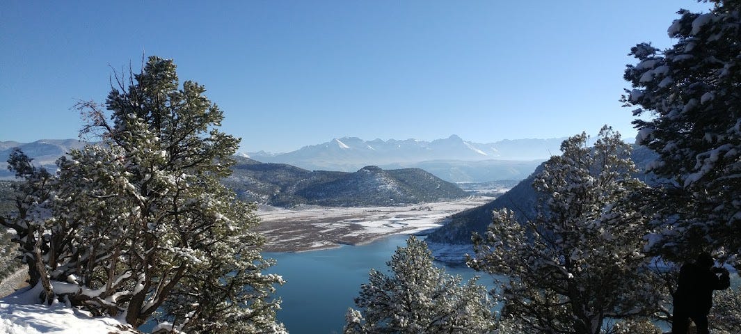 picture of mountains and a lake- it’s a sunny day