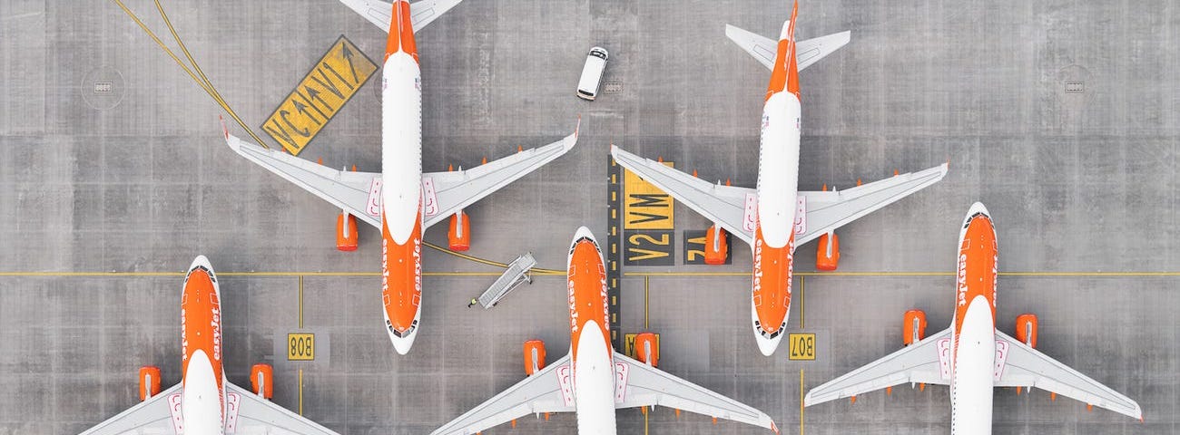 “AIRPORTS 100” by Tom Hegen shows grounded planes from above.