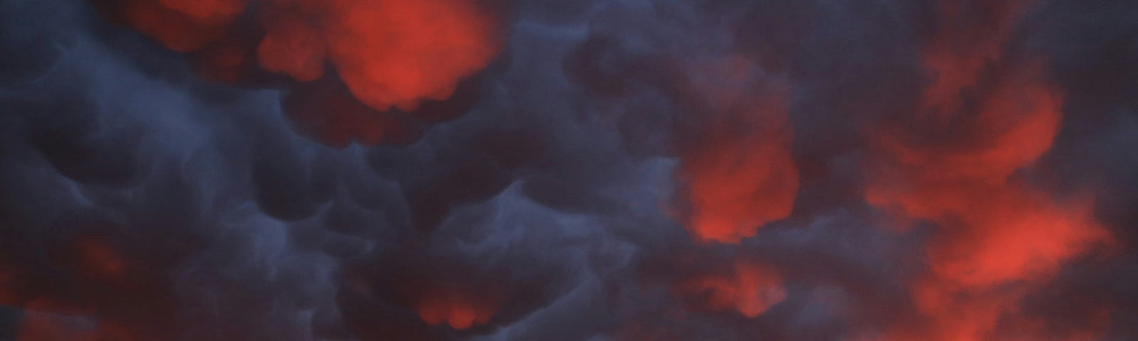 Dark smoky clouds lit up red