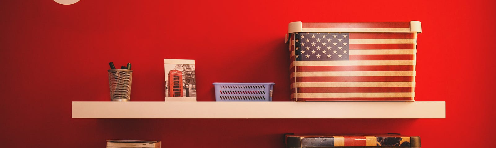 Two boxes on shelves. One with American flag, the other with British flag.