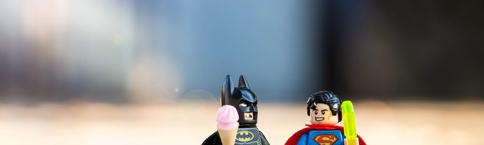 Lego Superman and Batman figures holding ice-cream
