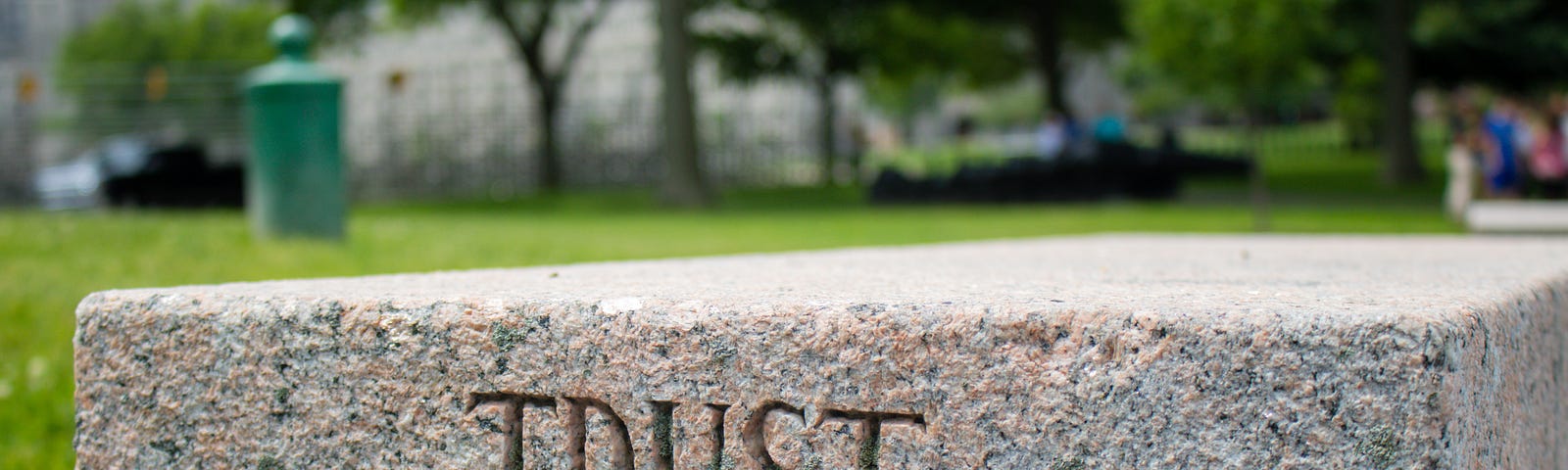 A stone slab with the word “Trust” engraved on it