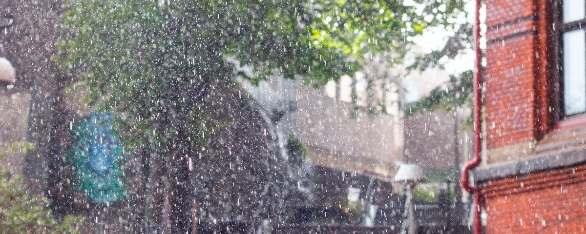 Rain showers pouring on buildings