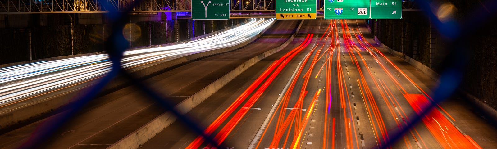 A night timelapse pciture of a freeway in Houston, Texas