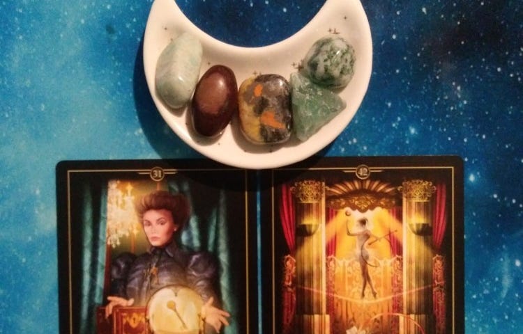 Two Oracle of Visions cards with crystals on a blue starry background