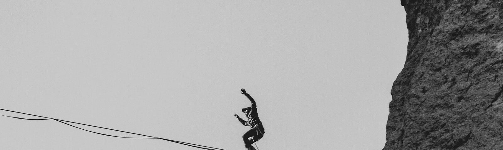 A man balancing on a tightrope.