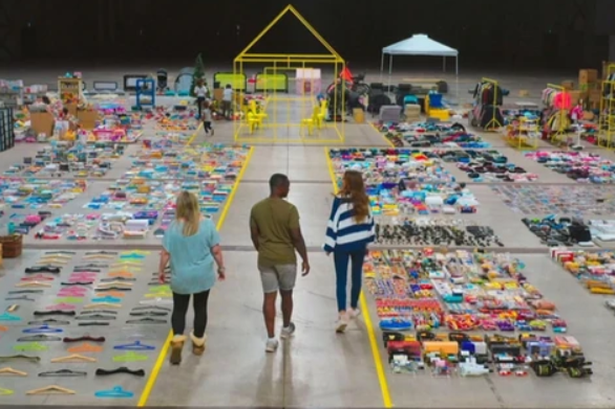 Stacey and householders in a warehouse full of their belongings