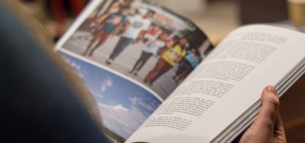 A woman reads a longer content piece in a magazine.