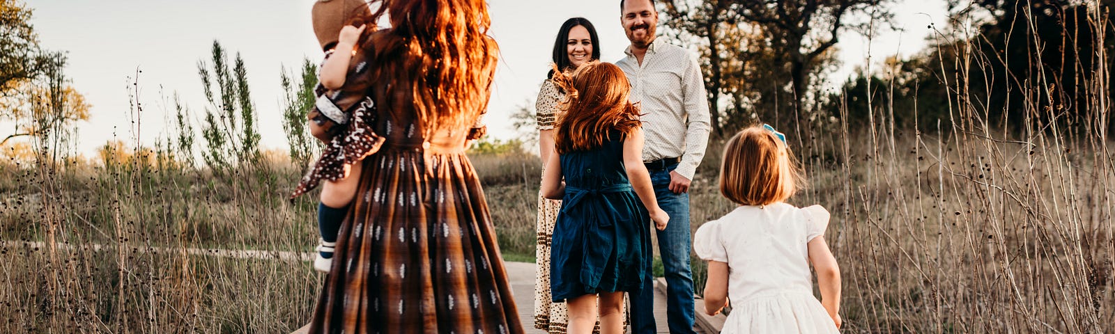 Photo of children running towards parents on a boardwalk