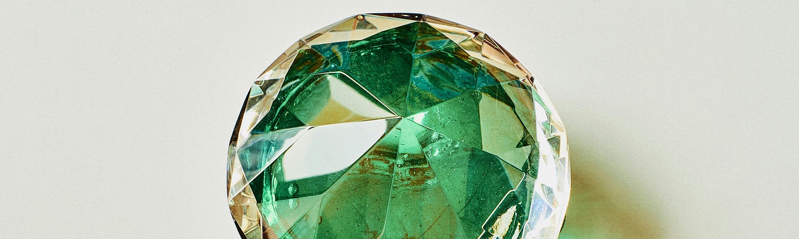 Glass crystal in the shape of a diamond with a green center