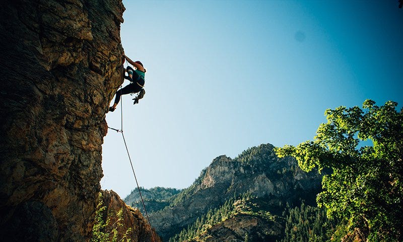 A woman sport climbing in a canyon.