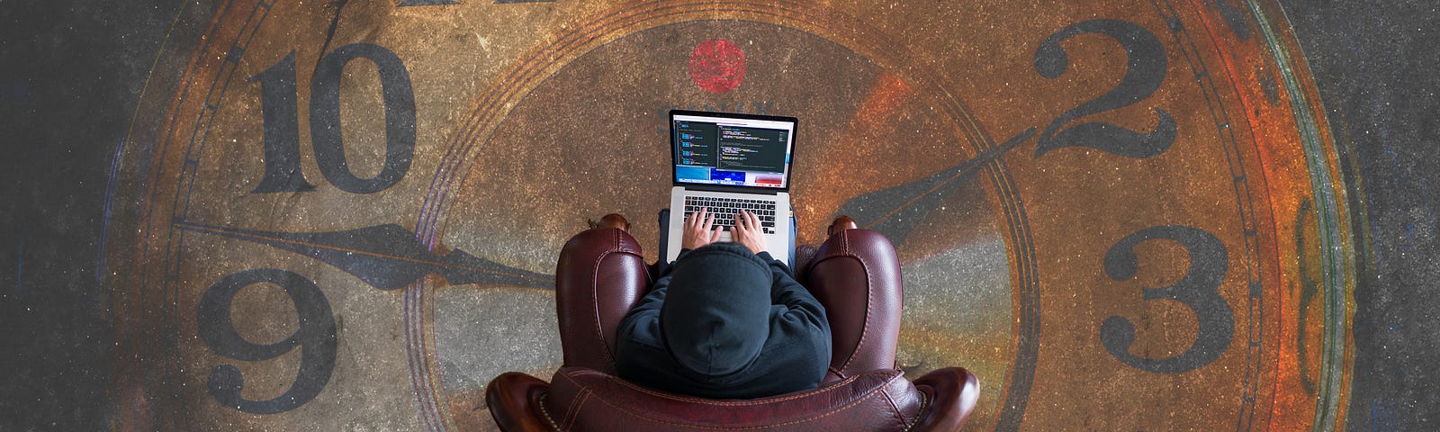 A man in a chair with a laptop sitting on a mural of a clock.