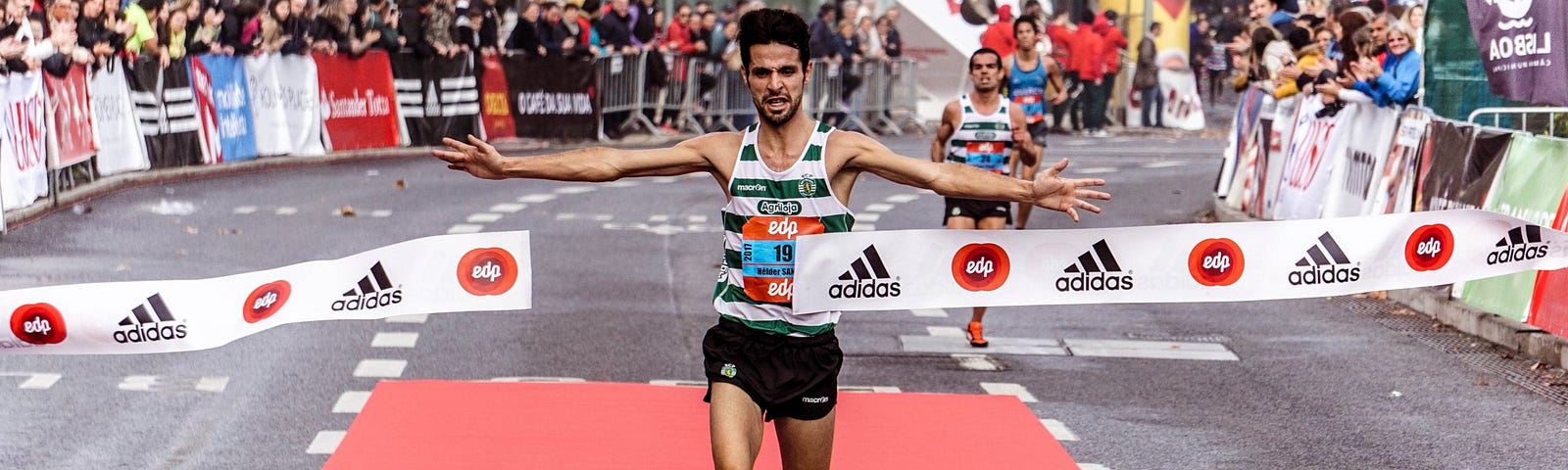 Man running past finishing line