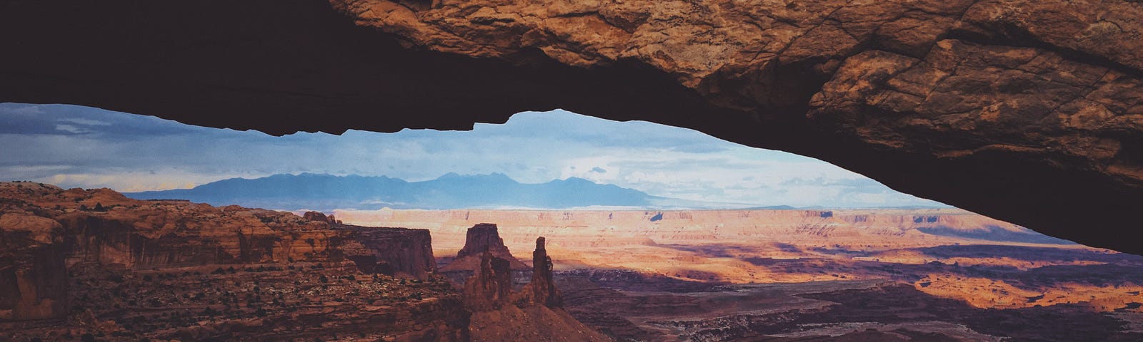 A rock structure, desert visible beyond.