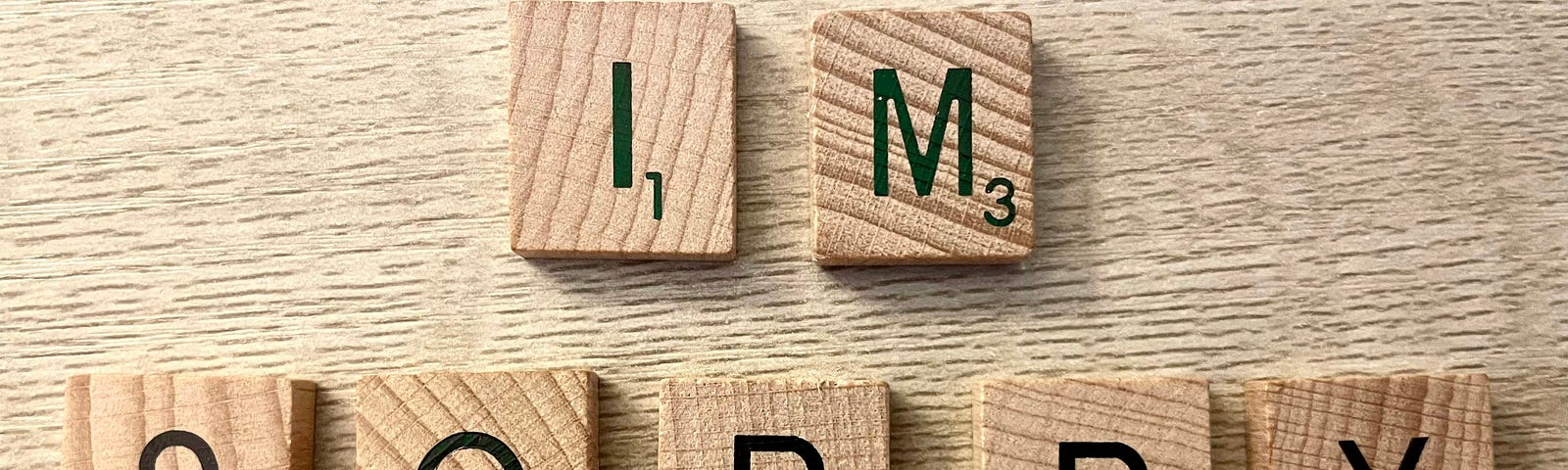 Scrabble pieces that spelled “IM SORRY”