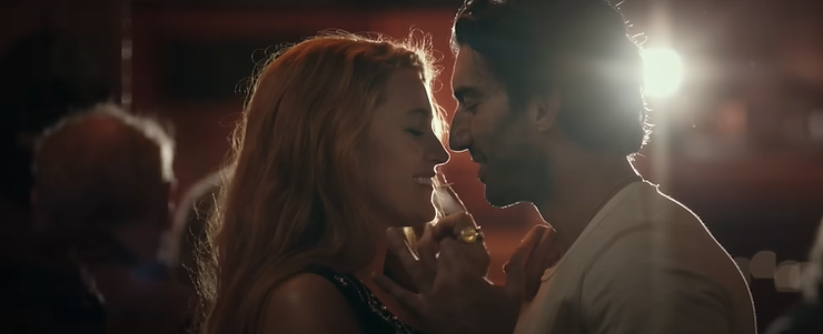 Blake Lively as Lily Bloom and Justin Baldoni as Ryle Kincaid dancing close together, backlit by a spotlight.