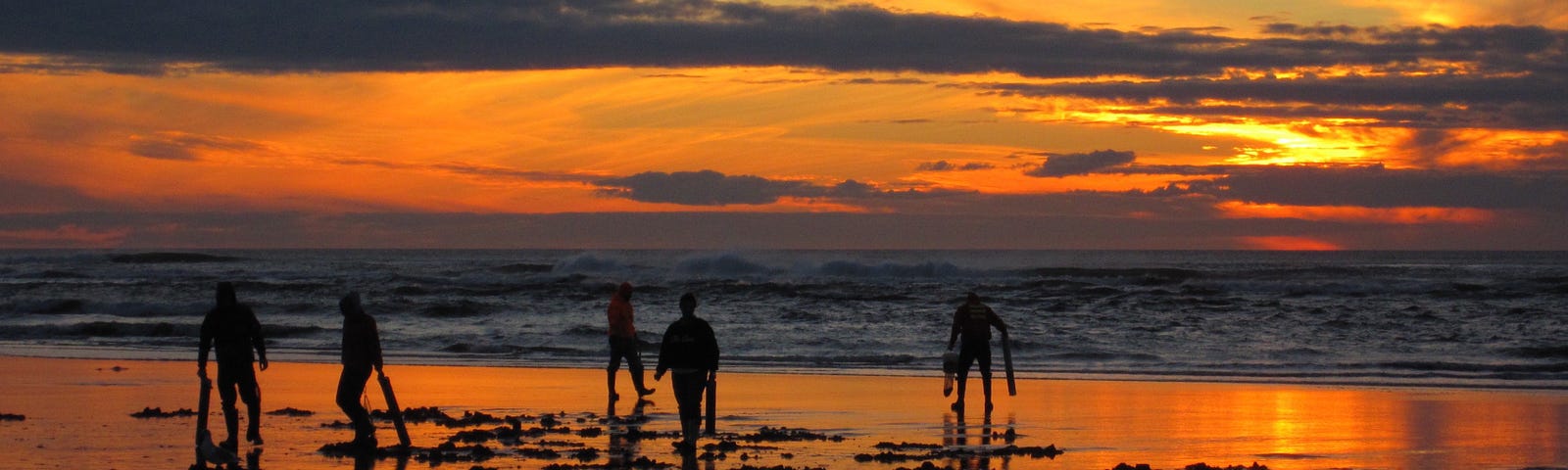 People on the beach at sunset