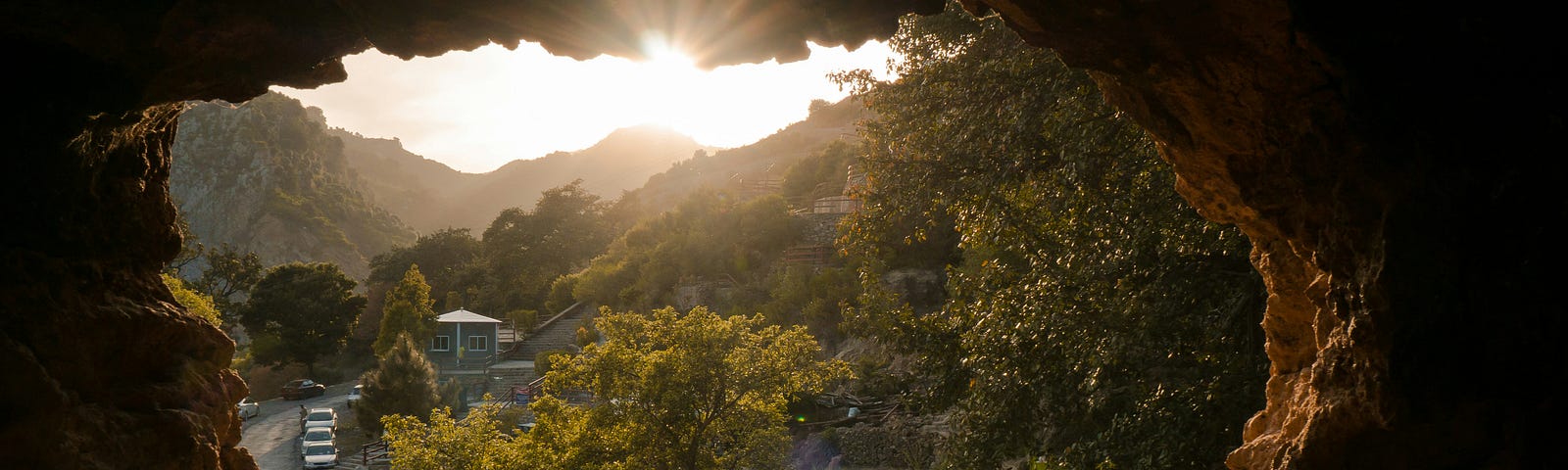 Sunrise through the jagged edges of a hole in the wall