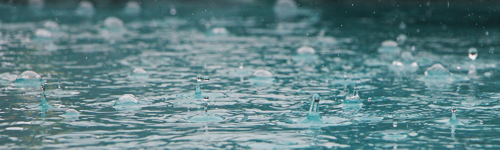 Rain drops landing on water
