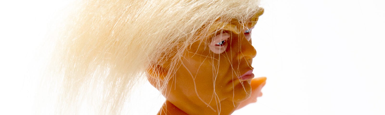 Naked Trump doll with wild hair.