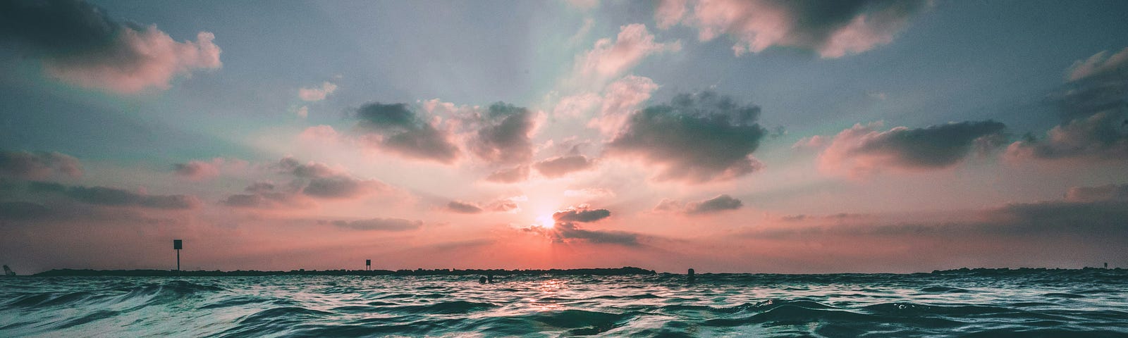 ocean waves and a pink sky