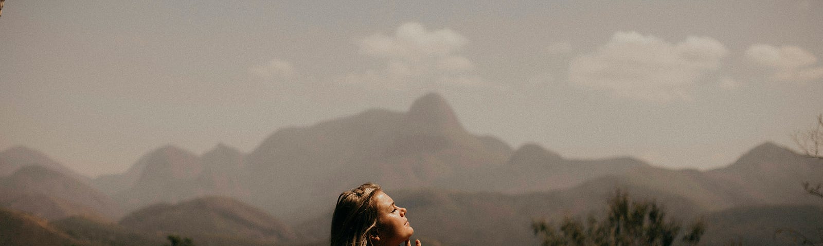 a woman standing and looking up in th sky