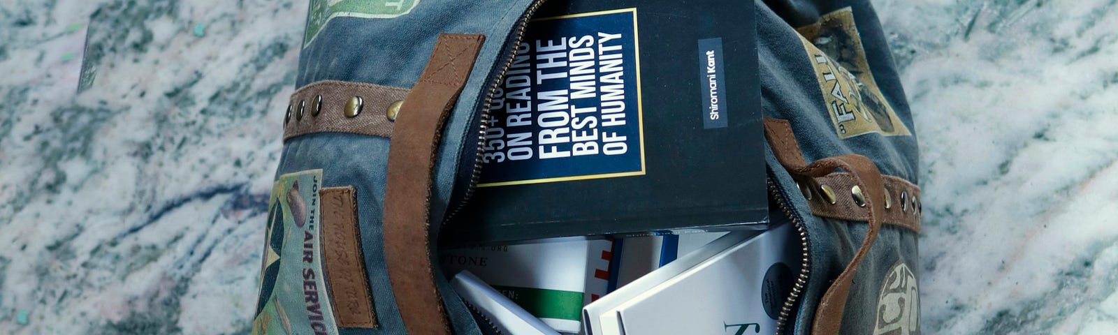 A bag with self help books spilling out of it