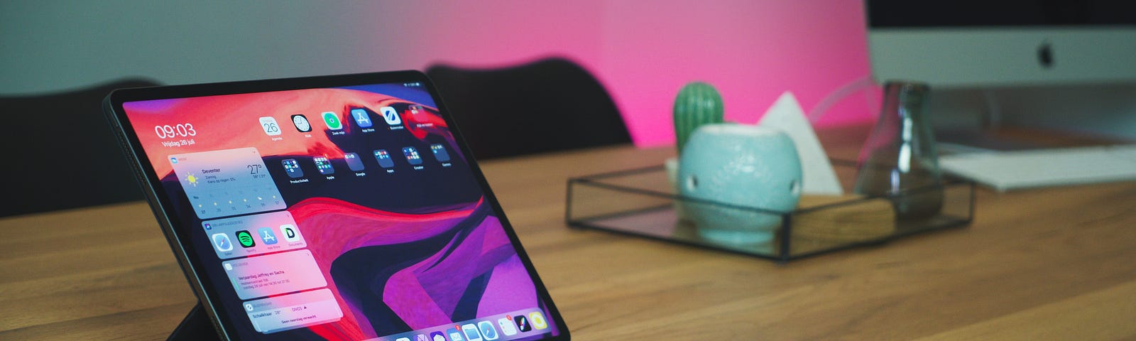 iPad, iPhone, Apple Watch, and AirPods on a table