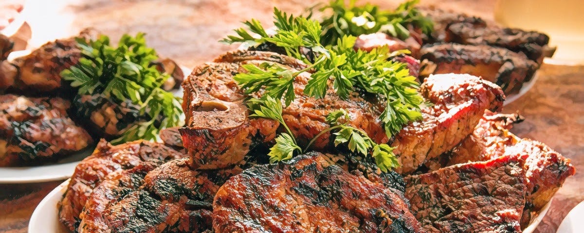 A platter of steaks with parsely garnish