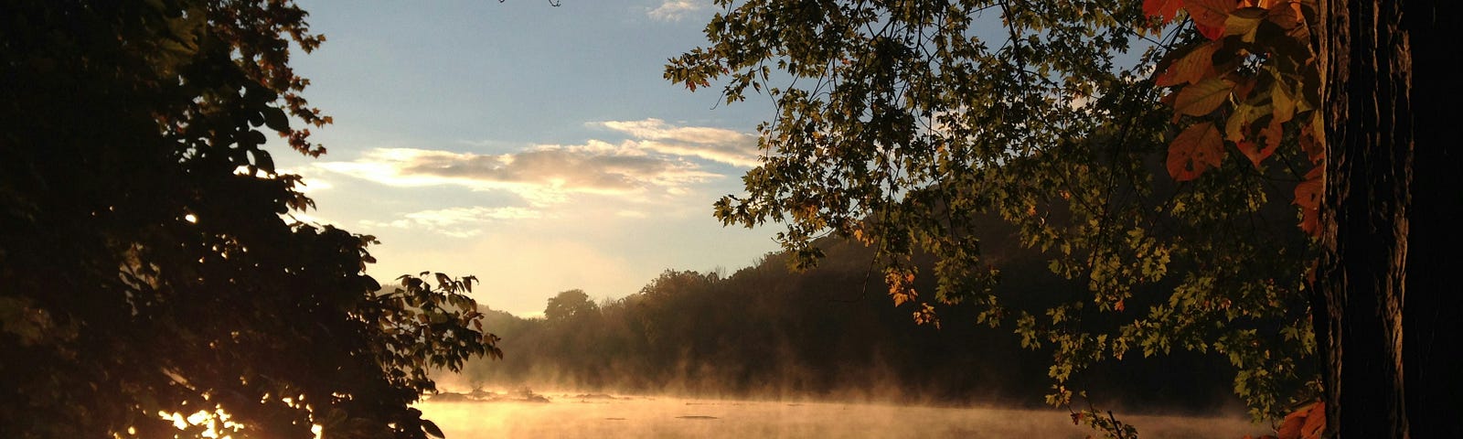 Sunrise over a pond and field