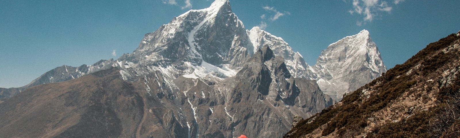 a mountain climber looks at the peak of Mt. Everest