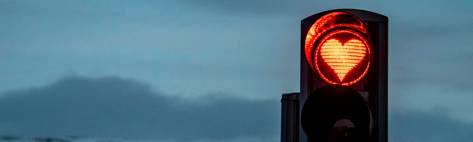 The red traffic light symbolizes waiting for a change that will never come unless we take action ourselves.