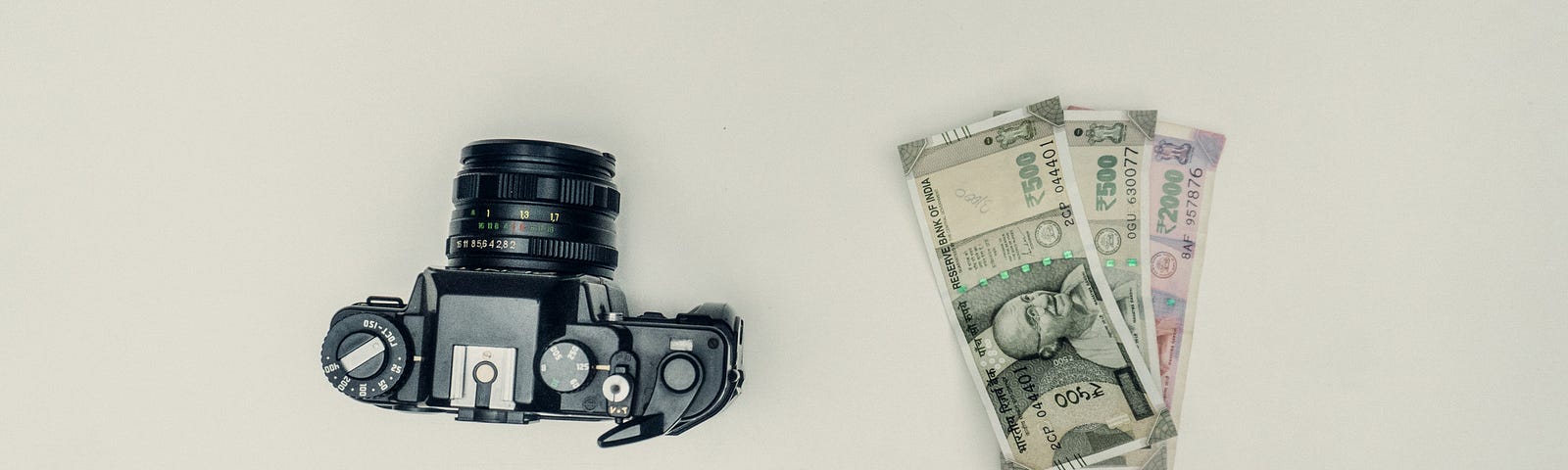 a vintage camera with cash