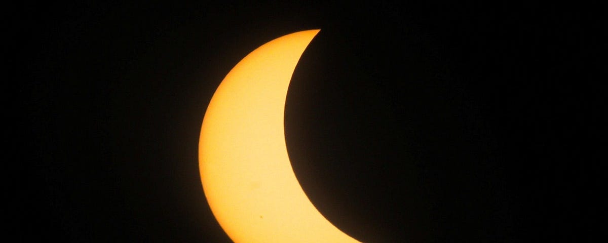 Sun’s light half blocked by the moon in solar eclipse.