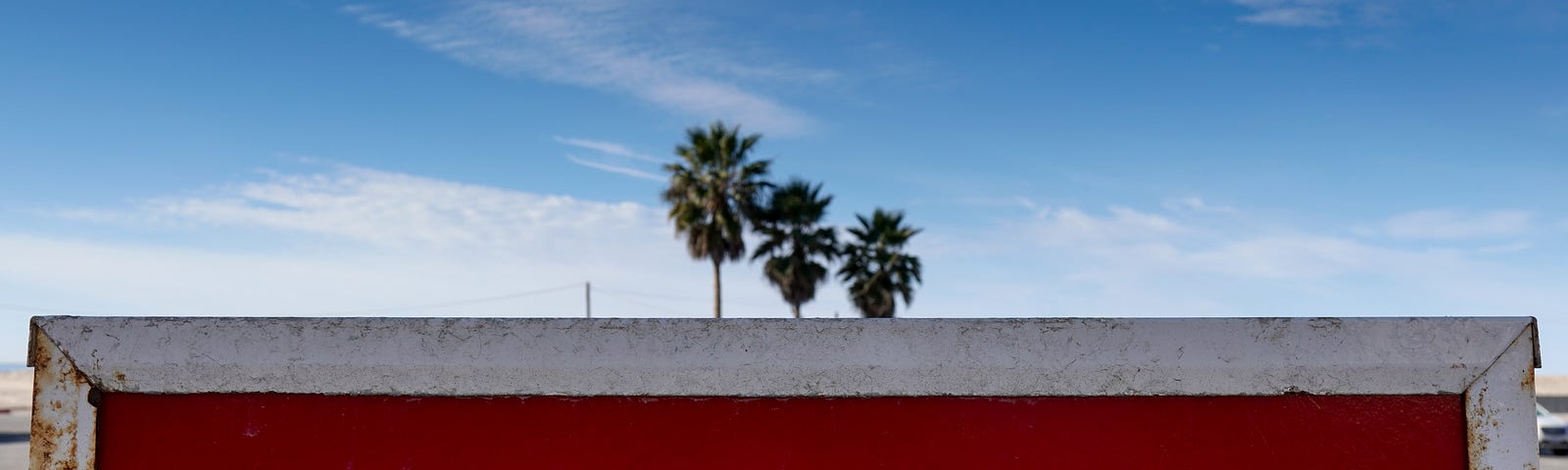 Sign saying wrong way. Has a blue cloudy background with palm trees. Medium writers are using Twitter the wrong way.